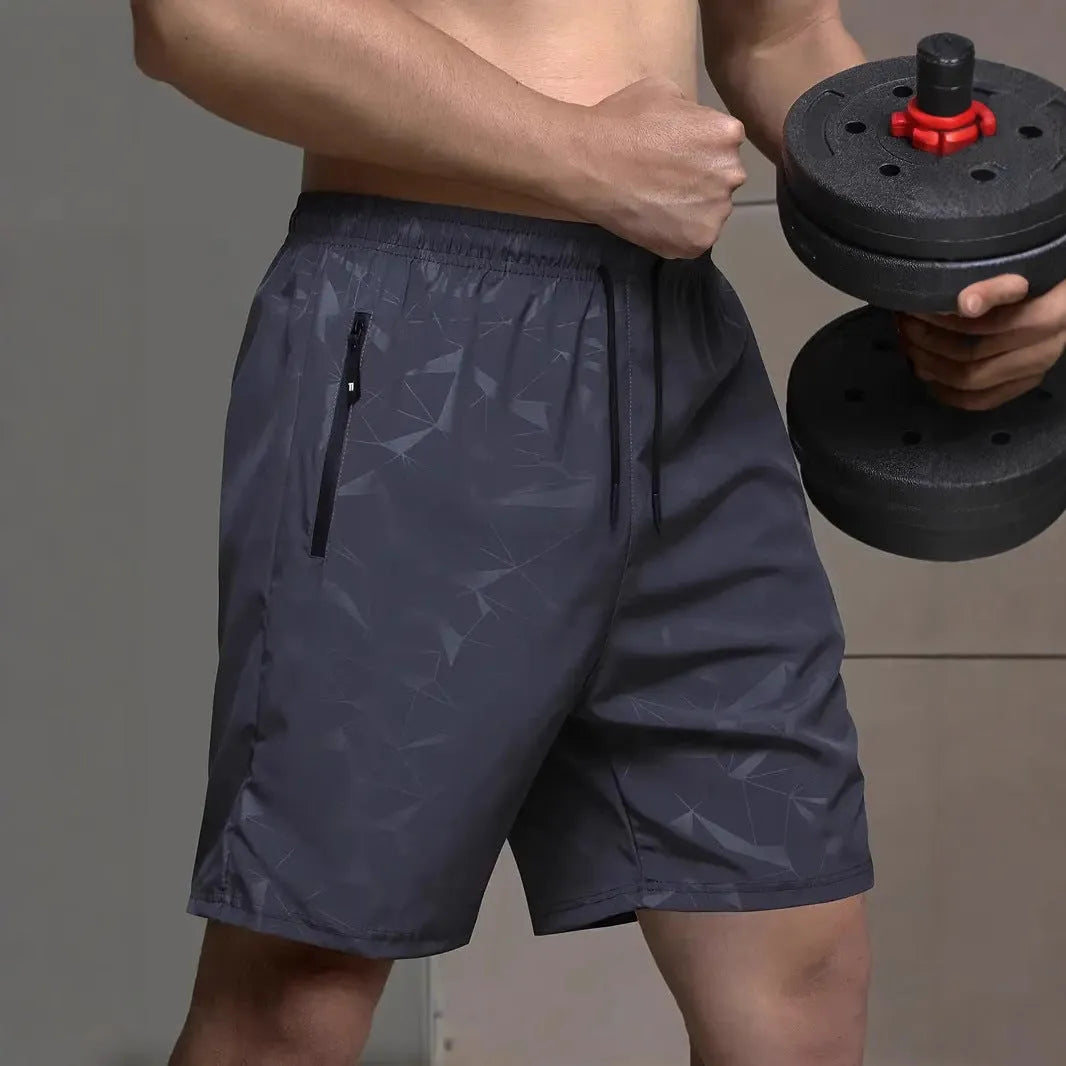 Man wearing loose-fit black printed polyester sports shorts for casual athletic wear.