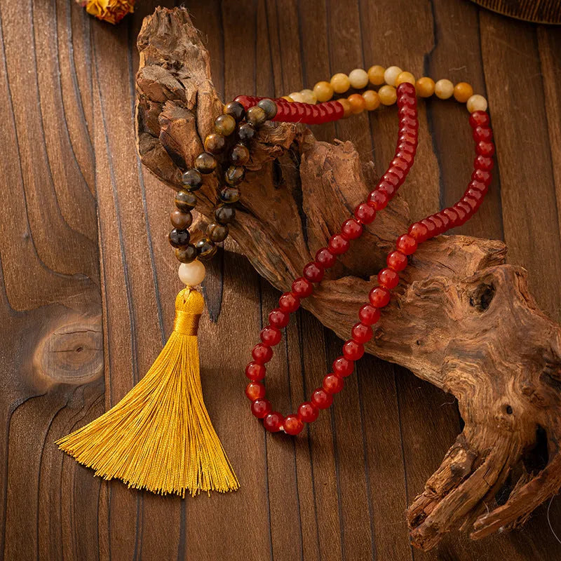 Vintage bohemian style natural stone bead necklace and bracelet set showing geometric round beads and tassel detailing