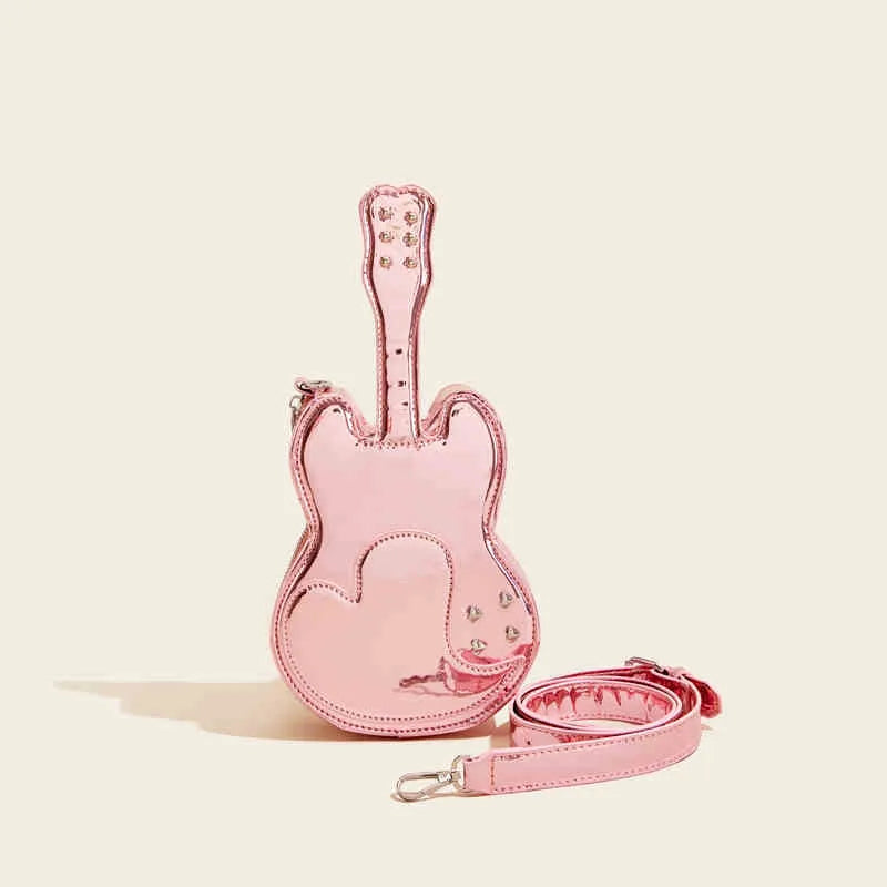 PU leather guitar-shaped crossbody bag in silver, shown with phone and wallet inside.