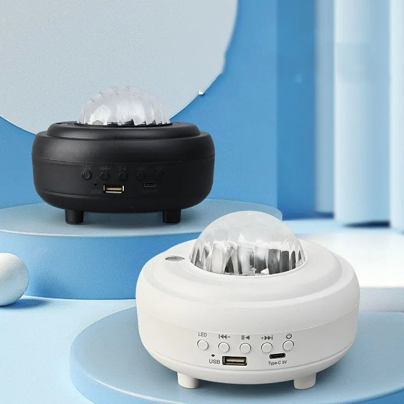 White Bluetooth galaxy star projector night lamp showing starry sky projection on a wall.
