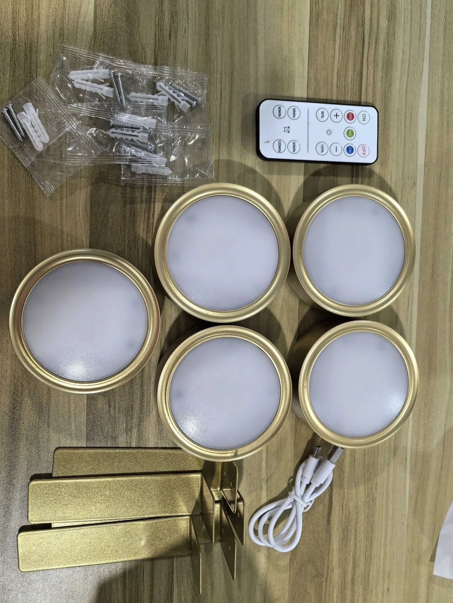 Wireless rechargeable LED painting lamp with magnetic belt attached to a metal frame, remote control nearby.