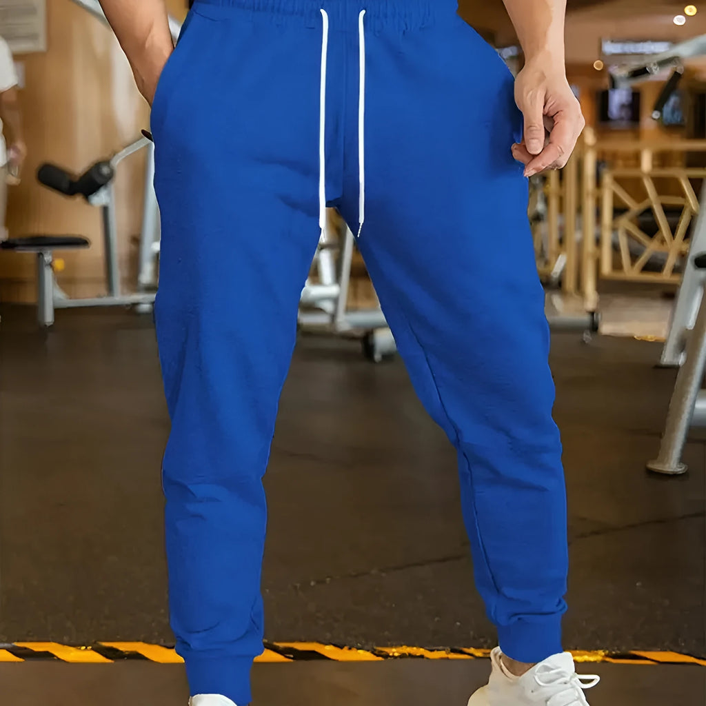 Man wearing grey lightweight linen-style casual trousers with an elastic drawstring waistband.