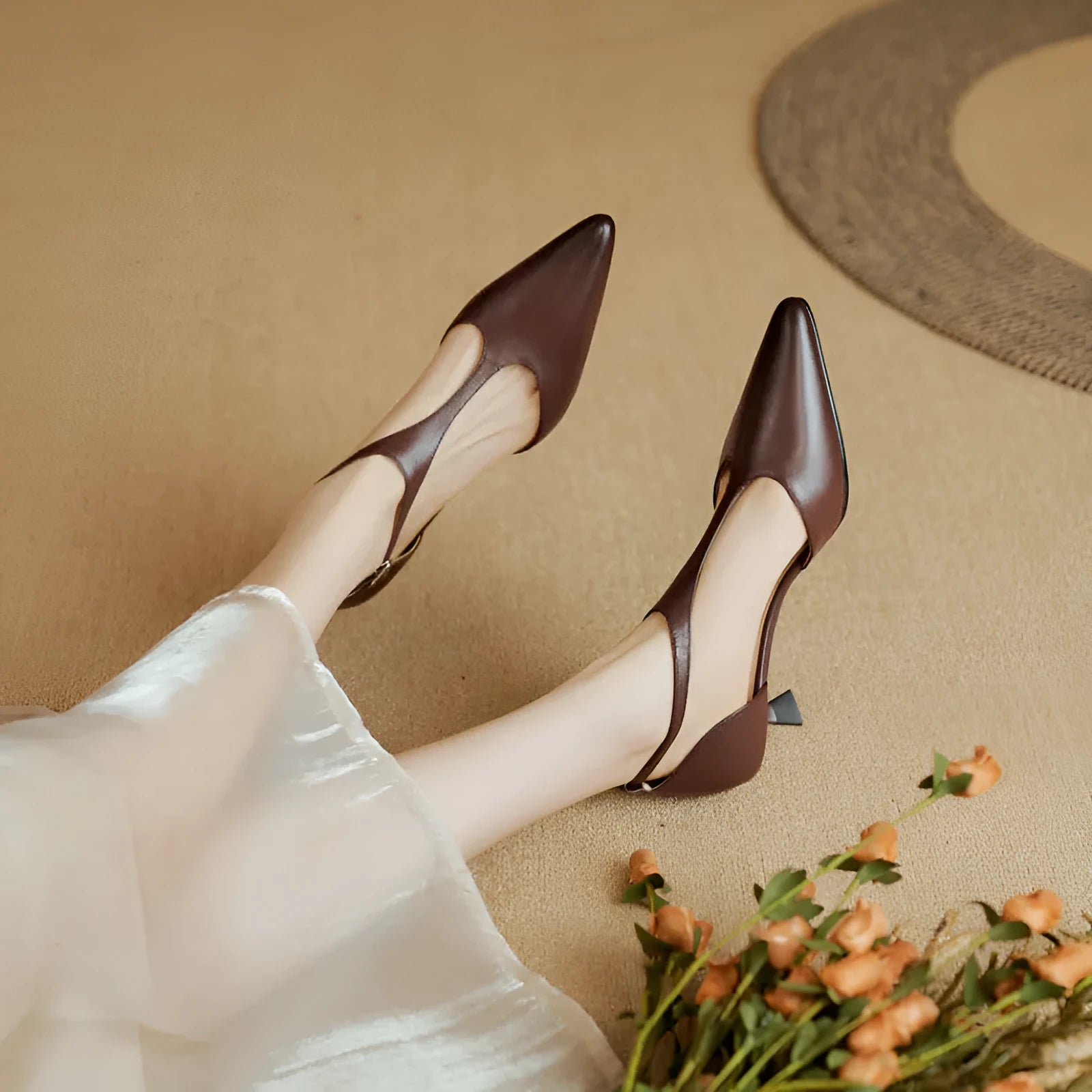 Women's vintage brown high heel shoe with a pointed toe and cowhide upper