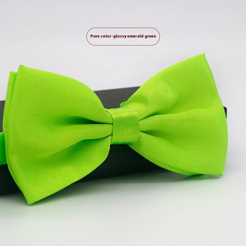 Men's flat head style polyester bow tie in a solid colour, shown with adjustable neck strap.
