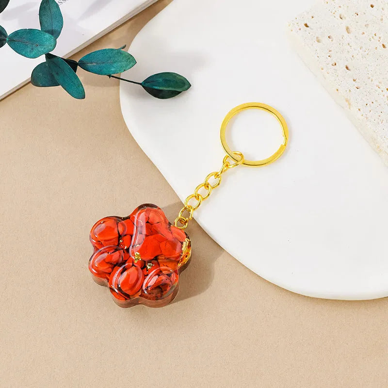 Natural crystal cat's paw keychain pendant in assorted gemstone colours on a keyring.
