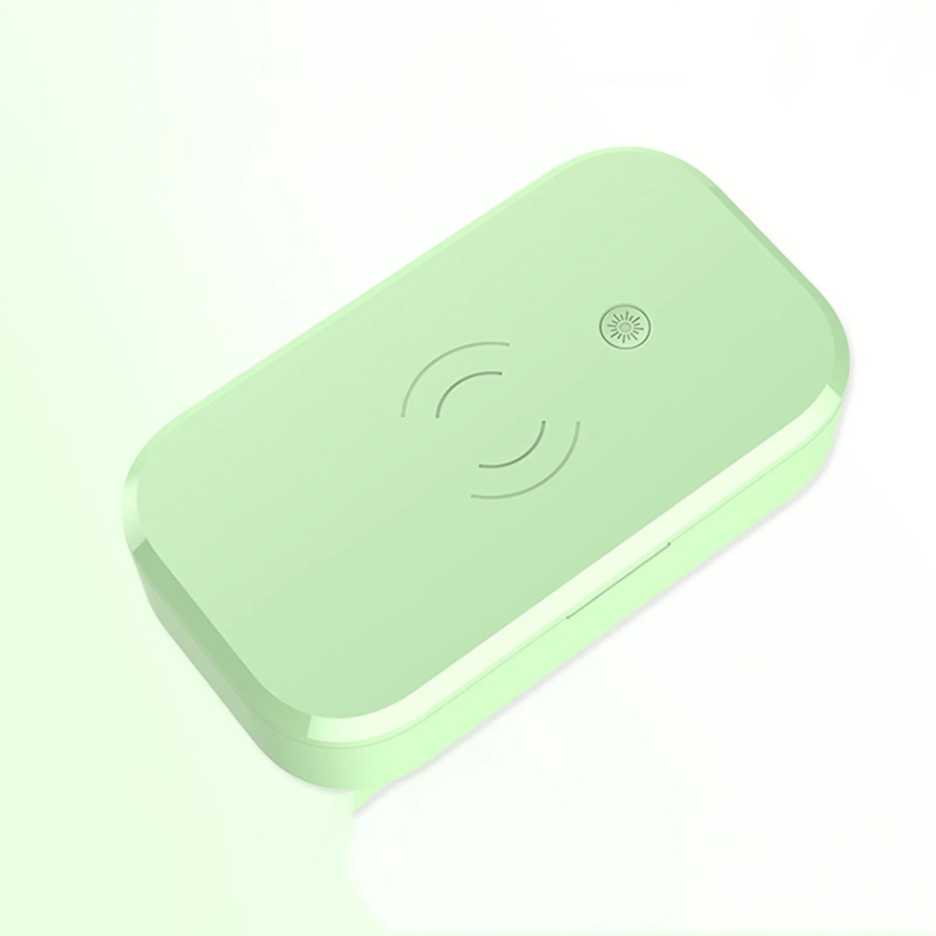 White ultraviolet disinfection box with wireless charging pad for mobile phones and nail tools.