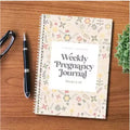 A5 Pregnancy Weekly diary notebook open showing weekly sections with 165x240mm dimensions