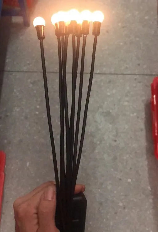 Solar-powered LED garden ground light with multiple light heads and a stainless steel spike for installation.