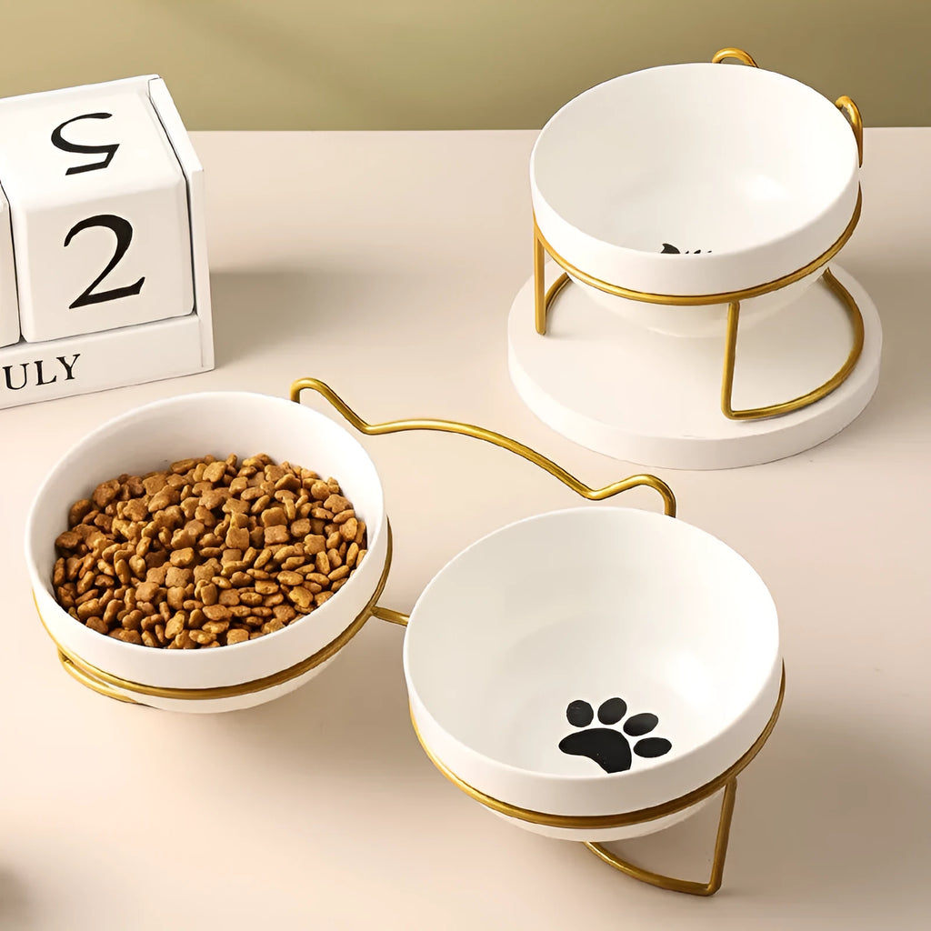 White ceramic cat bowl with decorative patterns on iron frame with cat ear details