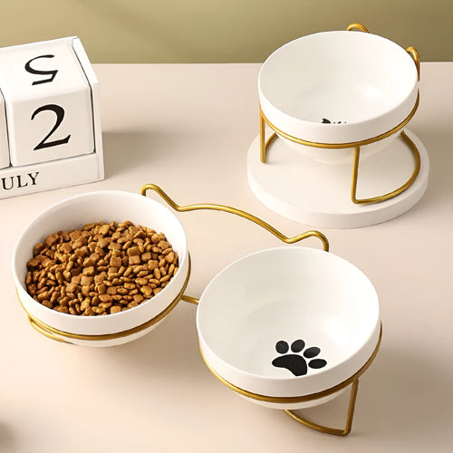 White ceramic cat bowl with decorative patterns on iron frame with cat ear details