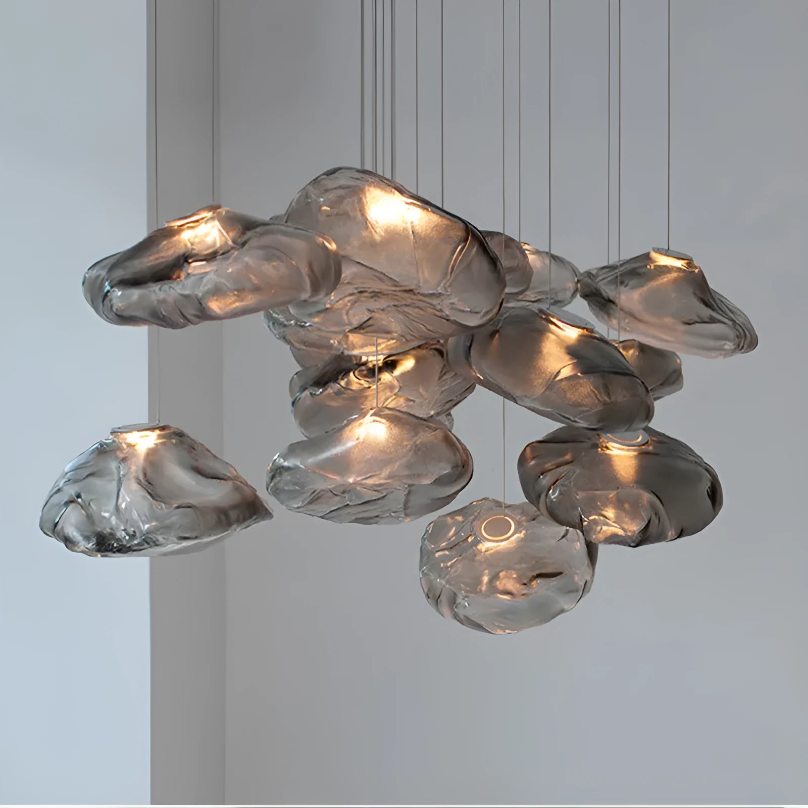 Modern fabric-style glass LED chandelier with clear, amber, or smoke grey shade, shown in small and large sizes.