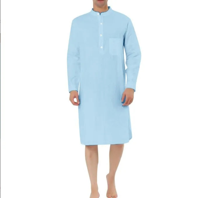 A man's long-sleeve cotton shirt robe in a light blue colour, showing a button front and chest pocket.