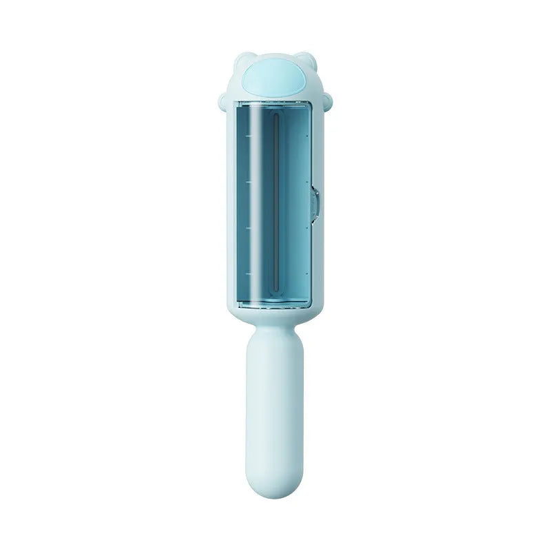 Blue pet hair remover roller with self-cleaning base on a fabric sofa.