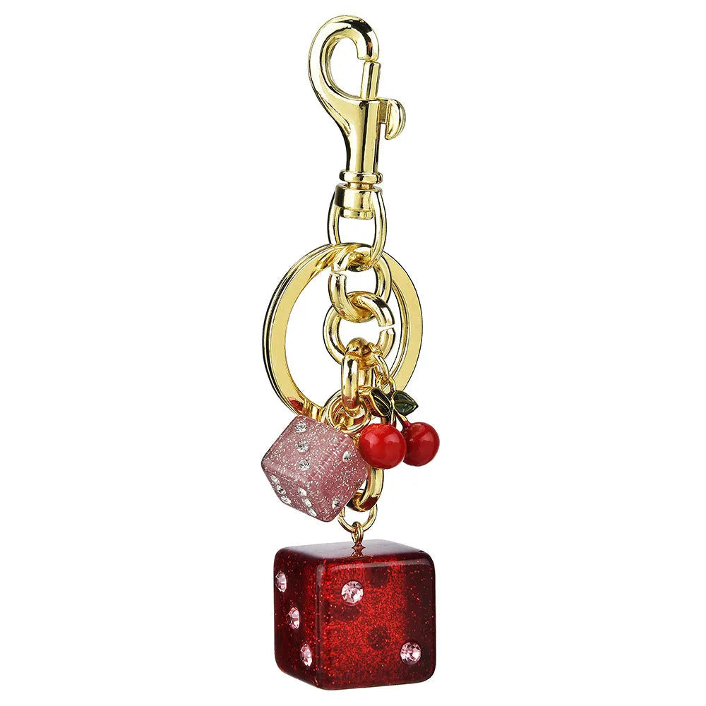 Vintage cherry two-tone square metal dice bag keychain pendant on a keyring.