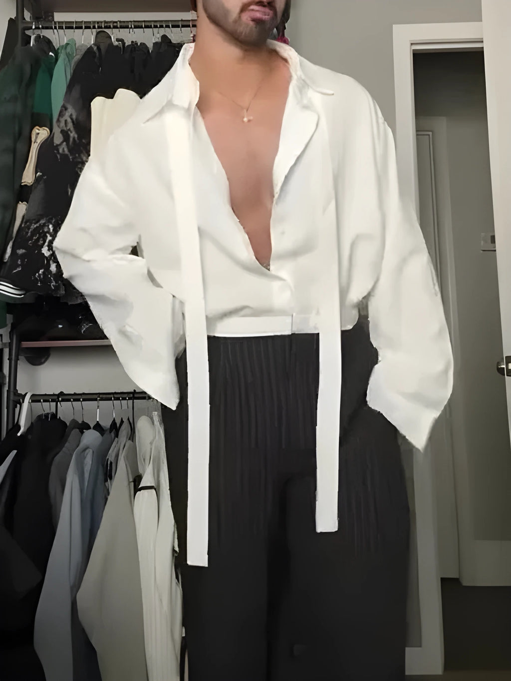 White oversized tie-front shirt with relaxed fit, open collar, and regular-length cut on a plain background