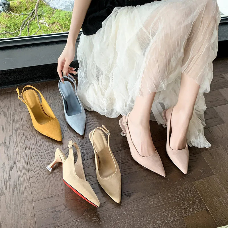 Apricot suede stiletto high heels with a pointed toe and rubber sole on a plain background.