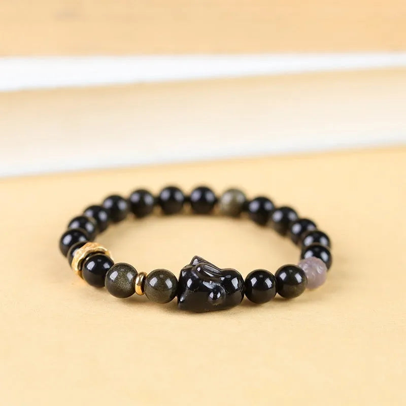 Handmade national style obsidian bracelet with a detailed lying rabbit centrepiece in jin yaoshi and grey agate.