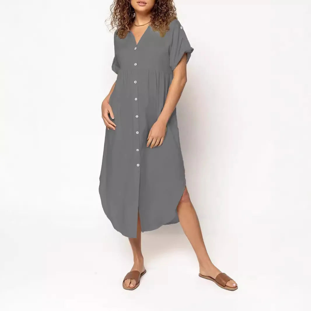 A loose-fitting, mid-length casual dress with button detail on the front, shown in a solid colour.