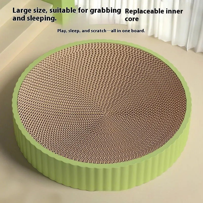 Green and white round cat scratching board with replaceable corrugated cardboard panels.