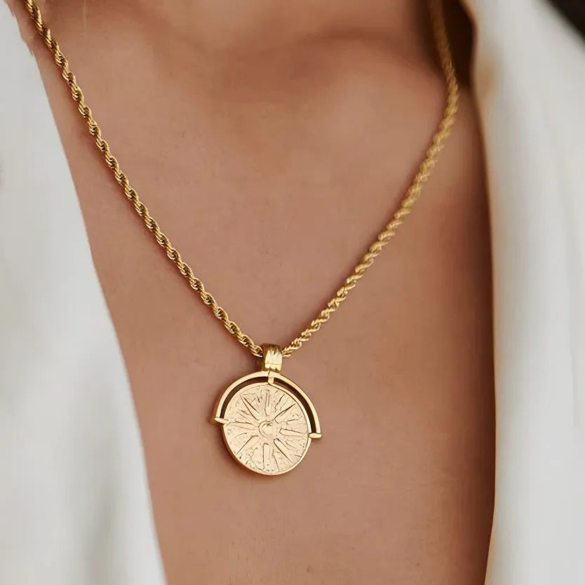 Gold stainless steel sunflower pendant necklace with geometric embossed design on hemp chain