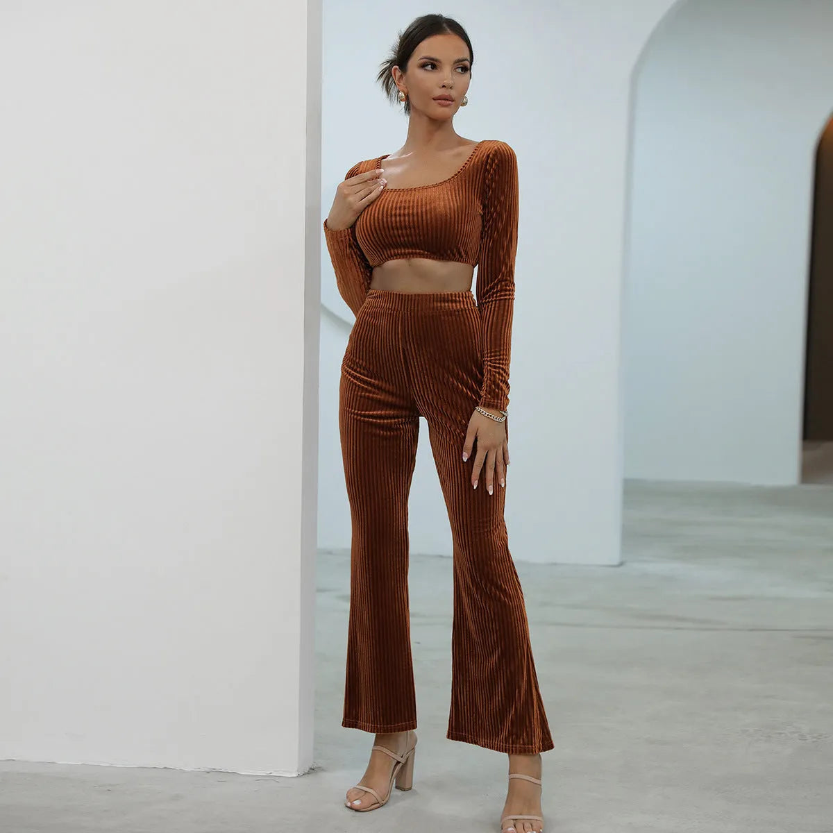 Caramel coloured long sleeve sweater and matching trousers lounge set on a hanger
