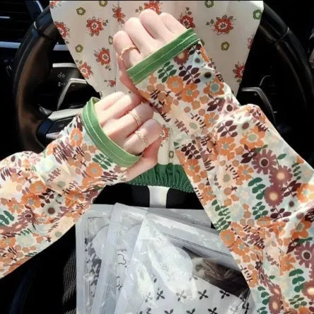 Printed viscose fibre sun protection oversleeves in floral design with elasticated cuffs.