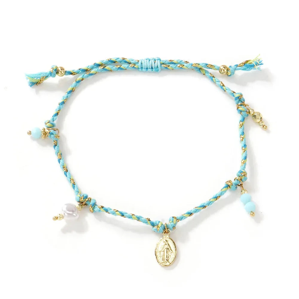 Close-up of a hand-woven colourful braided rope bracelet with an adjustable strap tag, showing ethnic style design.