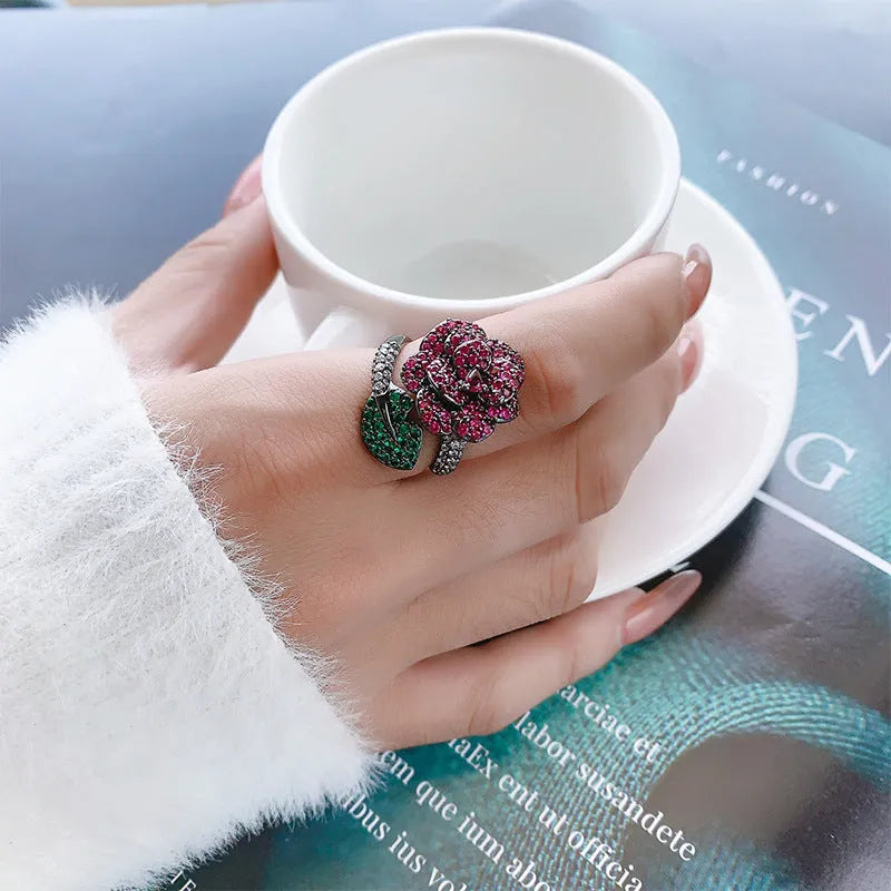 Gold-plated geometric flower ring with red simulated corundum stone on black gold band
