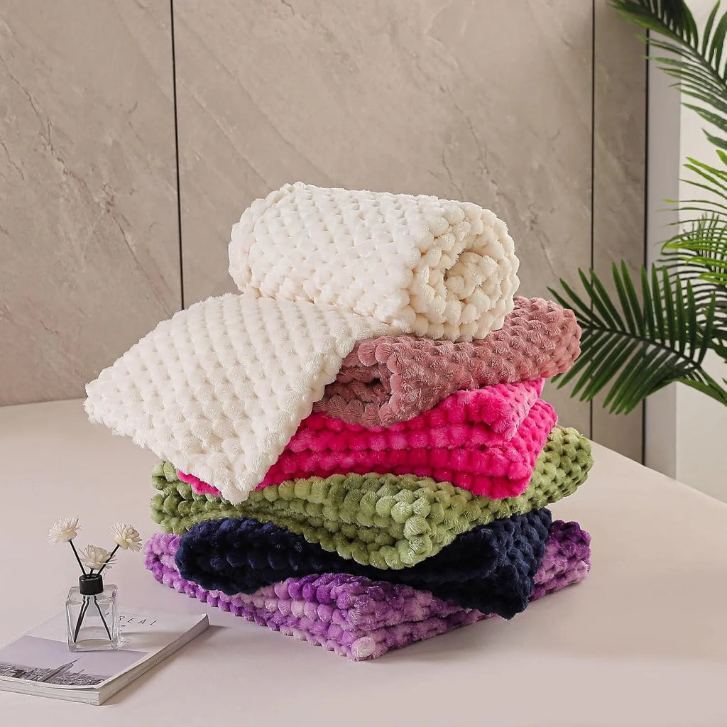 Children's soft plaid fleece blanket in camel colour showing texture and size.