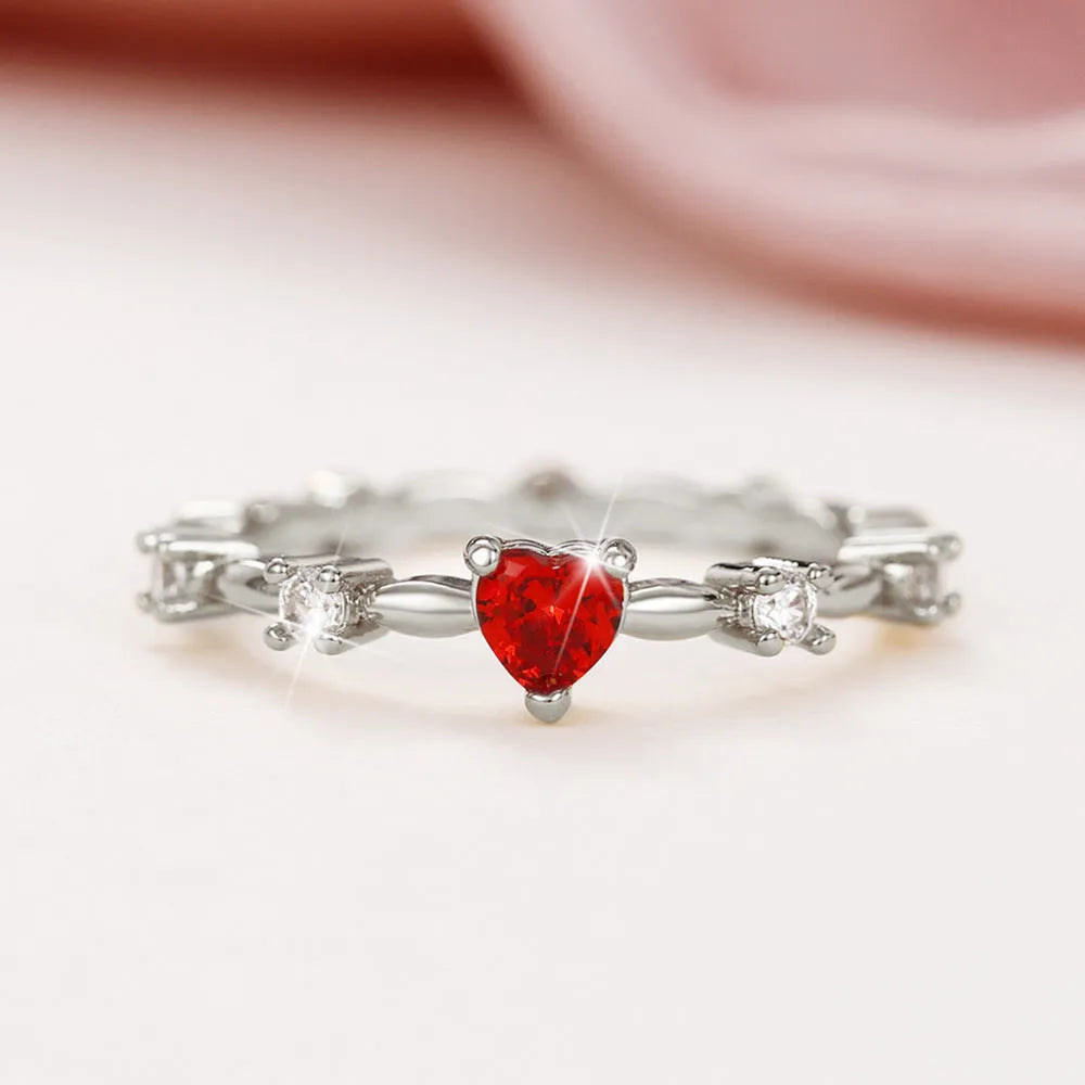 Gold and silver electroplated fashion ring with a peach heart charm and zircon stone.