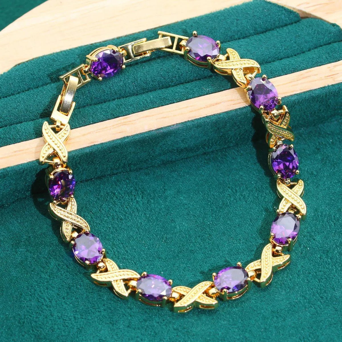 Gold plated jewellery set with colourful cubic zirconia stones, showing ring, earrings, bracelet, and necklace.