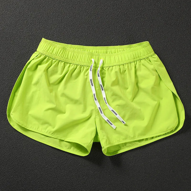 Men's loose fit beach shorts in polyester available in orange red, fluorescent green and black colours