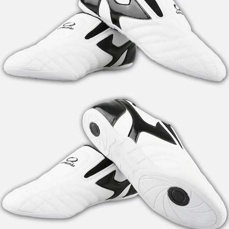 Black and white children's martial arts training shoes with a soft sole and widened design.