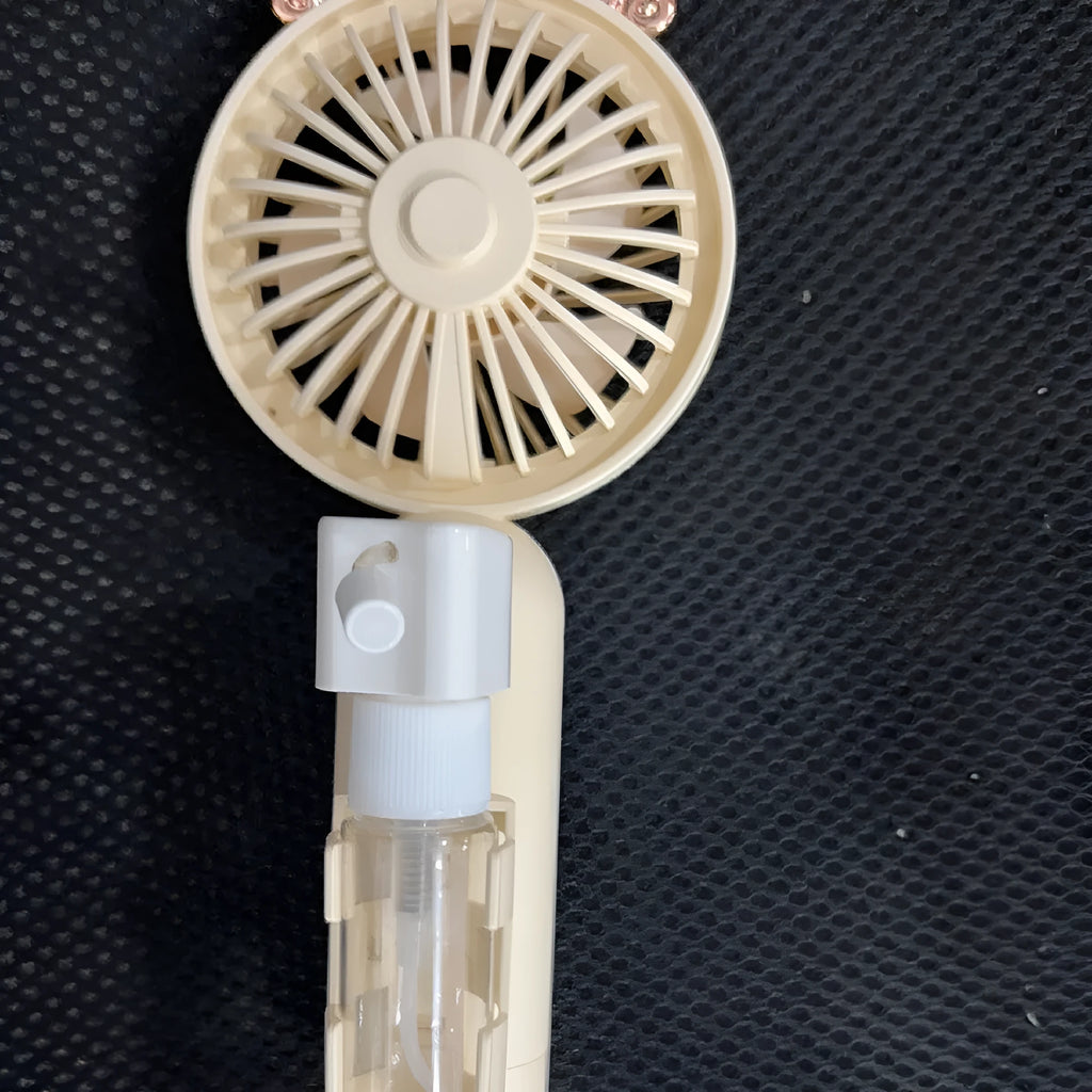 Small plastic nozzle fan in apricot colour with USB charging port