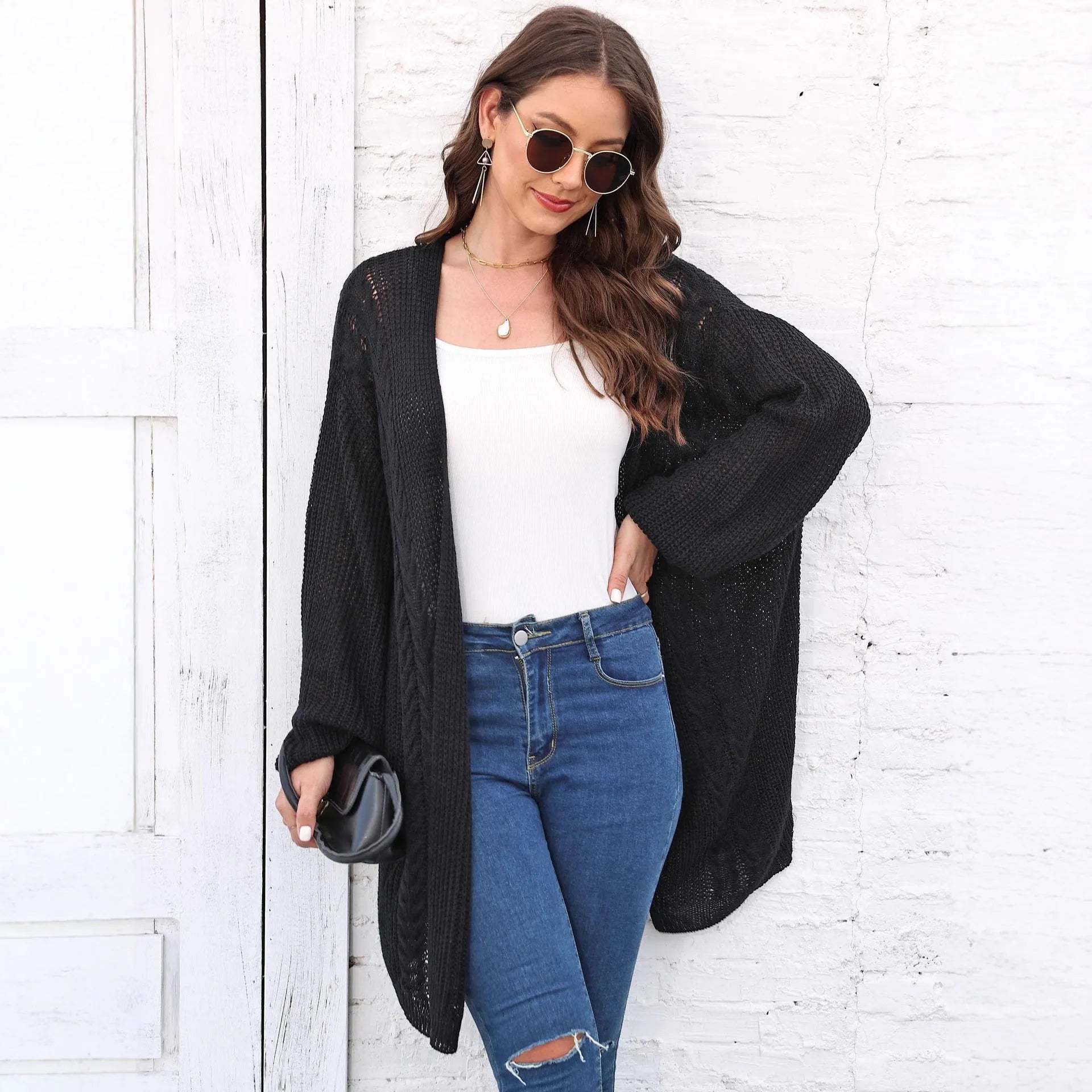Women's loose acrylic sweater coat in solid colour on hanger
