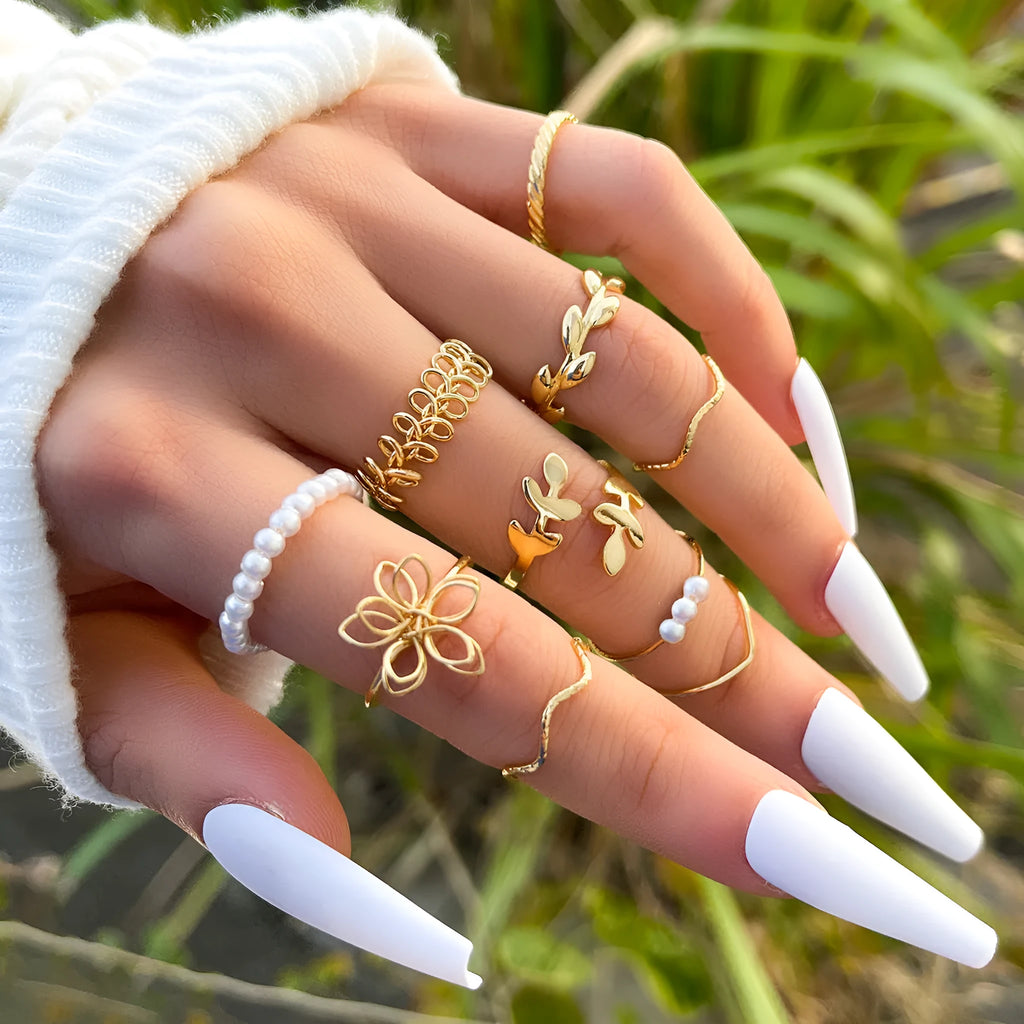 Gold tone openwork flower ring with electroplated glossy finish and women's jewellery design