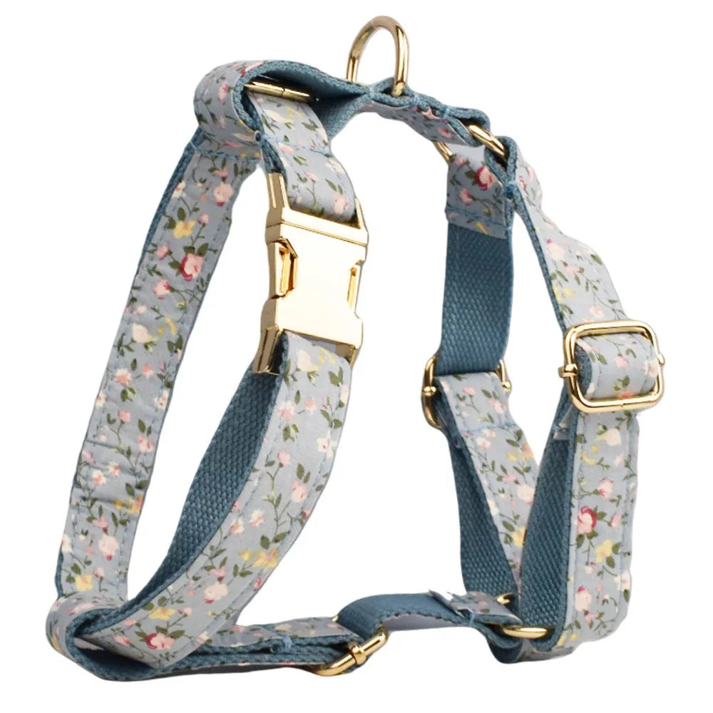 Blue floral pattern dog collar set with matching leash, bow, vest and waste bag dispenser accessories