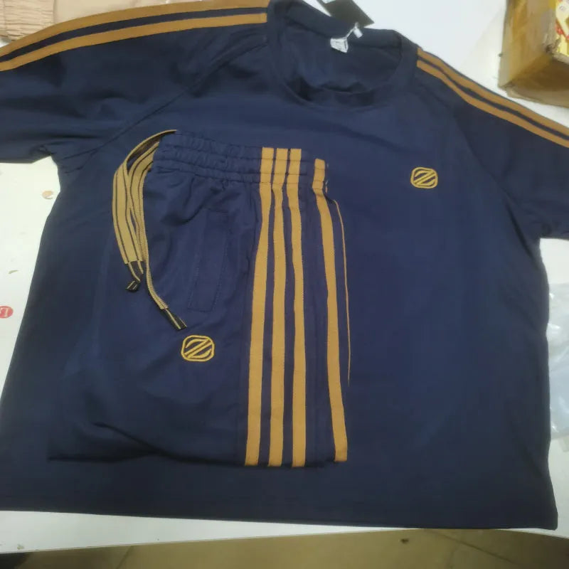 Men's blue short sleeve polyester suit set with matching top and trousers for sports activities