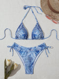 Denim blue printed women's bikini set with strap design on a model, showing front and back.