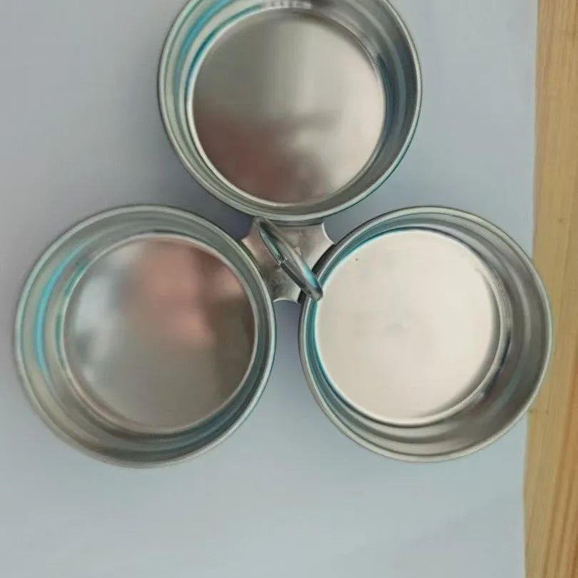 Small stainless steel heart-shaped egg steamer or cooker on a kitchen counter.