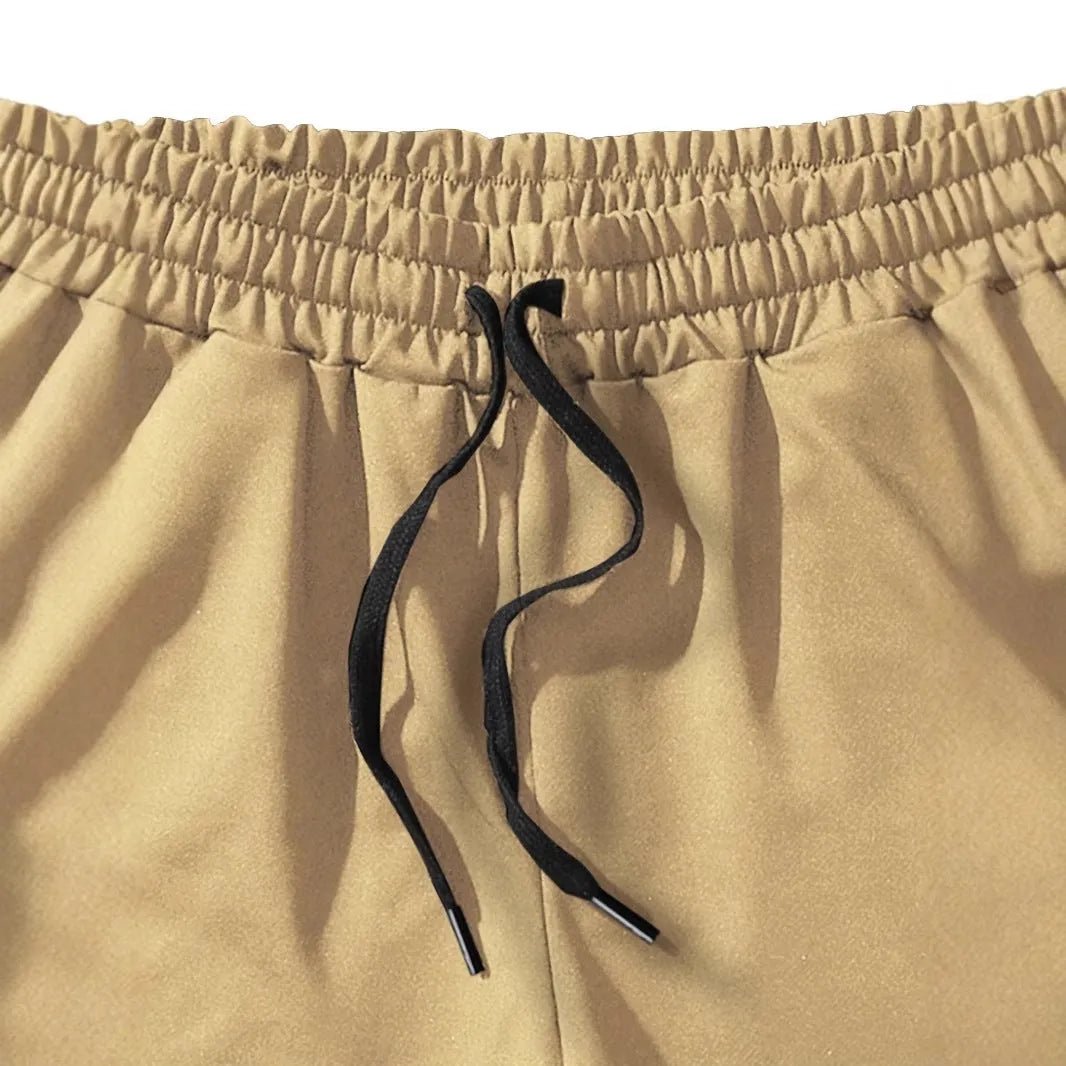 Khaki coloured men's sports shorts with coconut print design and straight cut for summer activities