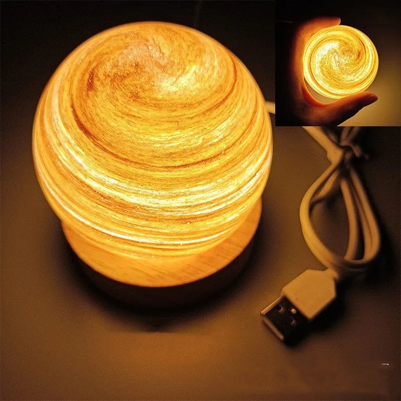 Planet night light with spherical design on base, USB cable connected, showing adjustable three-colour lighting