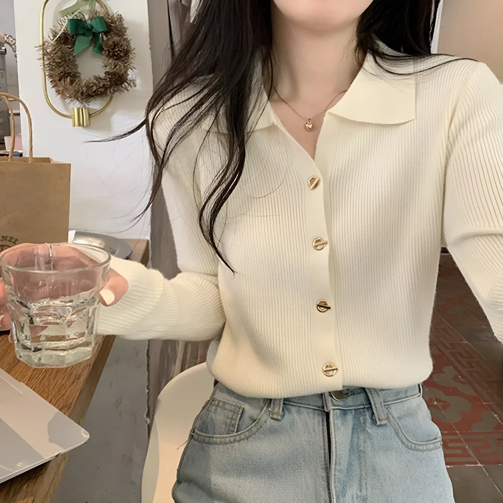 Long-sleeved loose knitted cardigan top in viscose fibre, shown in a neutral colour on a hanger.