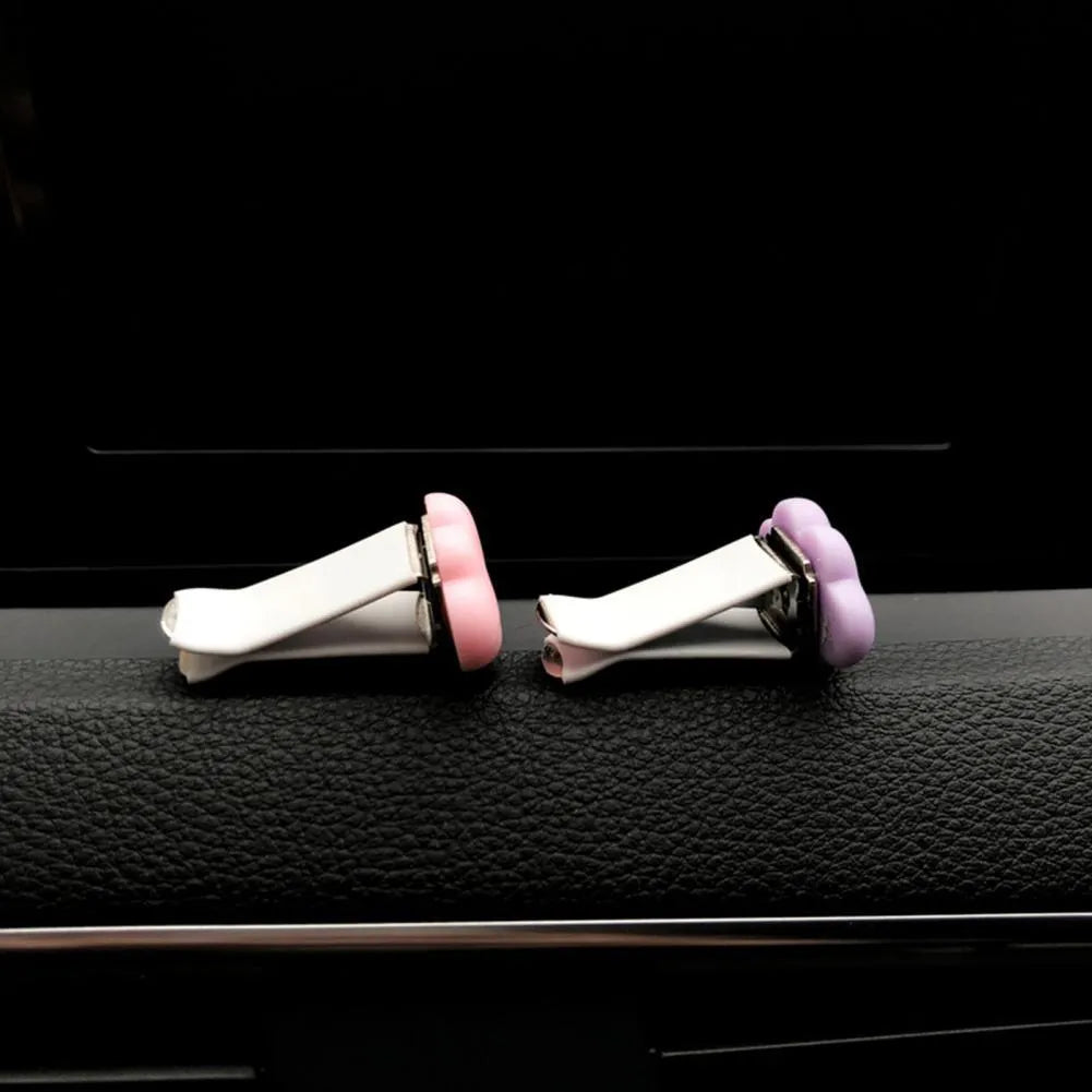 Resin car air vent fragrance clip in cartoon design, 17mm by 27mm, shown in one of six colours.