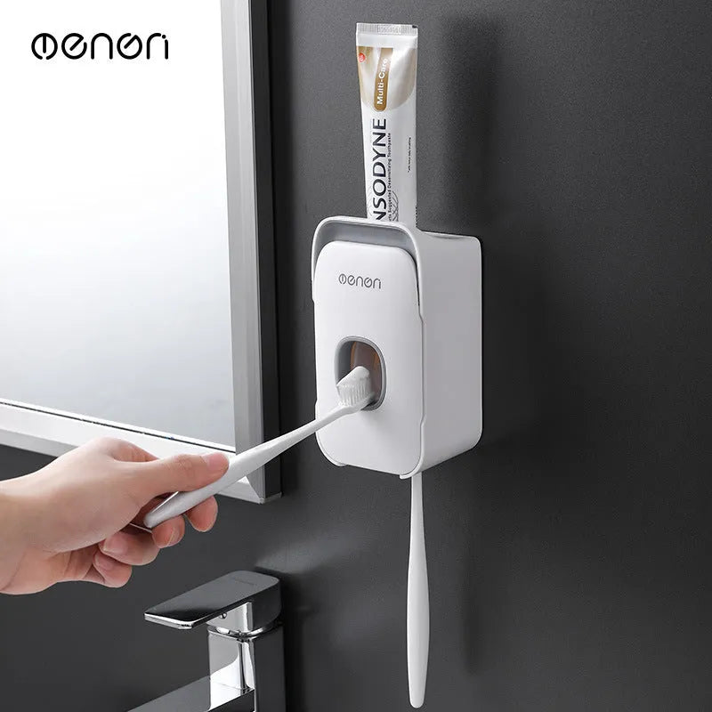 Blue automatic toothpaste dispenser made of ABS plastic on a bathroom shelf.