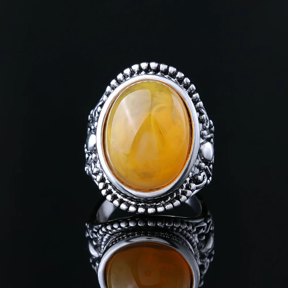 Geometric alloy ring with antique silver amber electroplated finish on a grey background.