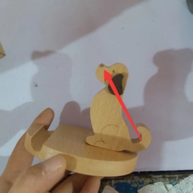 Beech wood mobile phone holder stand with coin slot and decorative carving.