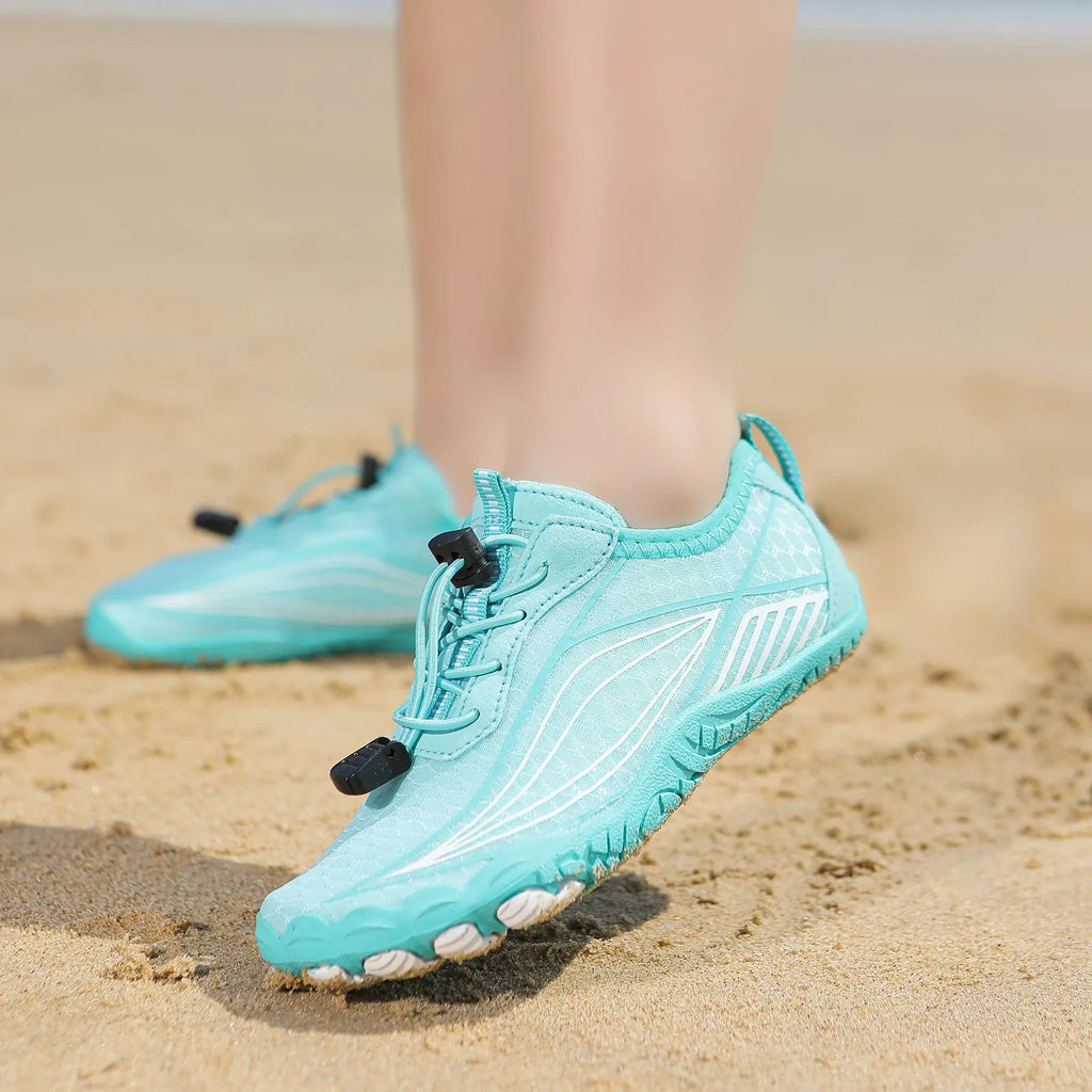 Children's black quick-drying water shoes with a non-slip rubber sole and elastic band.