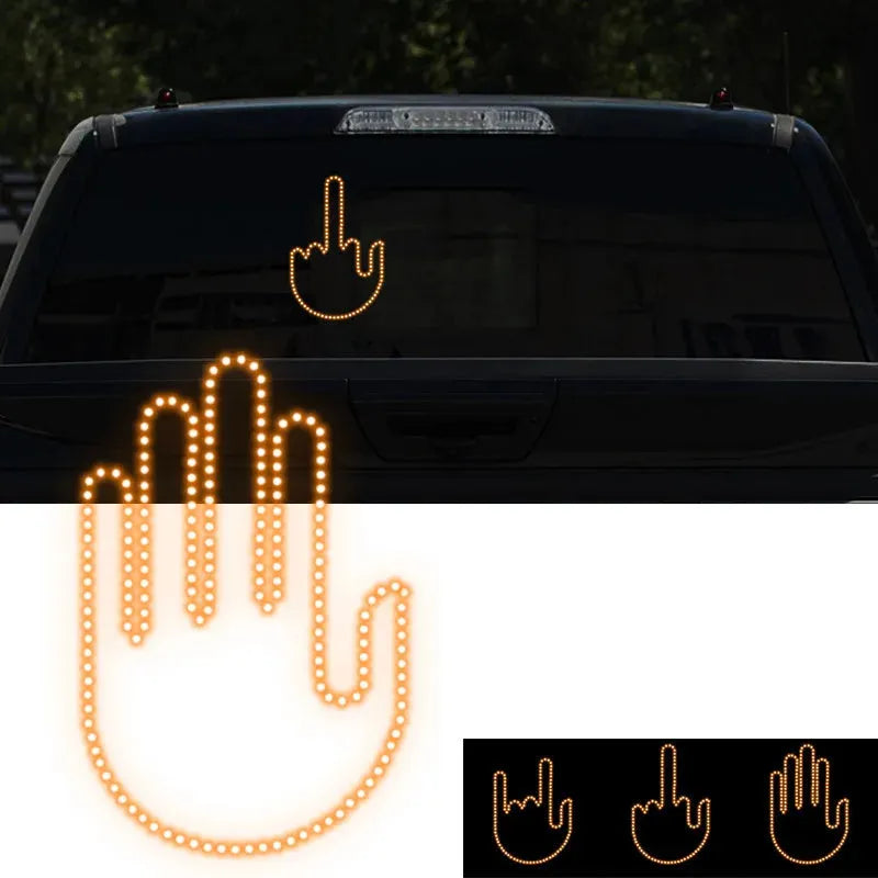 Black plastic LED gesture car light with amber LEDs showing a hand gesture, remote control, and 3M tape for mounting.