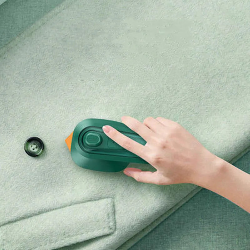 Dark green portable hanging steam iron with ceramic panel and power cord.